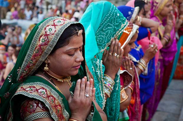 Women in Vibrant Traditional Indian Lehengas During Prayer | A Break Down of Hinduism and Christianity on Which Came First