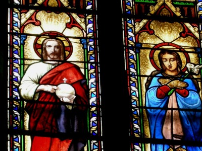 Why do many Saints fold their arms instead of their hands while praying?