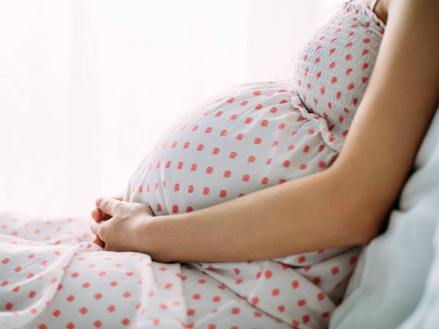 Pregnant Woman Holding Her Belly | When Does the Spirit Enter the Body: LDS Church Views | When Does the Soul Enter the Body?